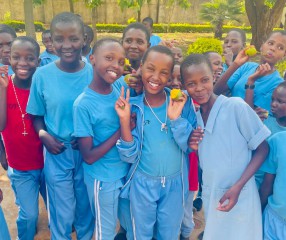 girls in blue shirts smiling